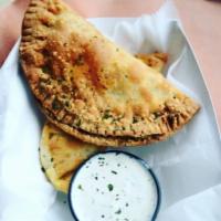 Brisket Empanadas · Smoked Beef Brisket , spinach, potatoes, cheese in crispy puffed pastry. Served with house m...