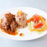 Stew Chicken · Includes a side of white rice or rice and peas and salad.