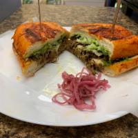 Torta birra de res · Just like the tacos de birra this torta is coated in red sauce with cheese and steak with a ...