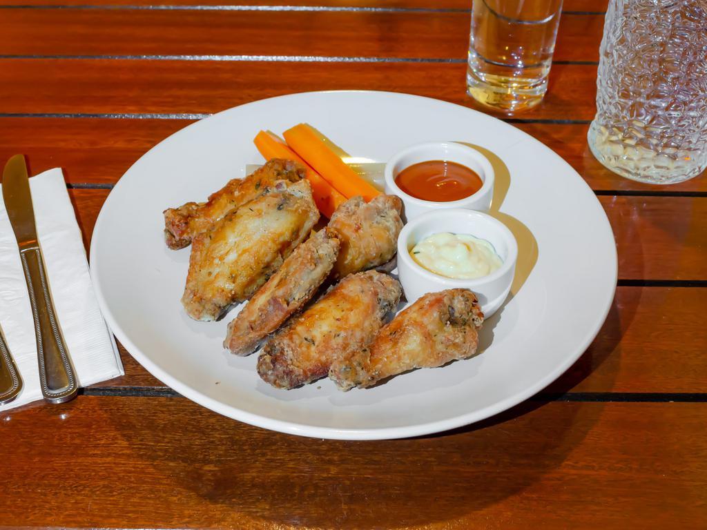 Confit Chicken Wings · Aleppo hot sauce, Parmesan aioli, pickled celery, pickled carrots.