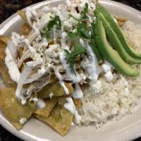 Chilaquiles. Verdes  · Corn tortilla  toasted on green tomatillo sauce toped with raw onions sour cream cheese fres...