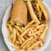 Philly Cheese Steak Sandwich with Onions · Served with french fries.