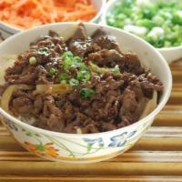 Bulgogi Bowl · Thinly sliced beef in Korean bulgogi marinade stir fried with onions, served over a bed of r...
