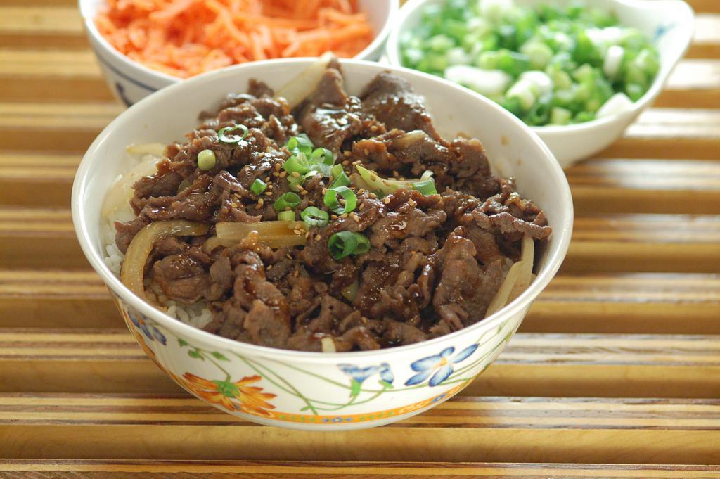 Bulgogi Bowl · Thinly sliced beef in Korean bulgogi marinade stir fried with onions, served over a bed of rice. Topped with toasted sesame seeds and green onions