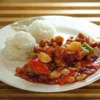 Sweet and Sour Chicken · Classic Chinese sweet and sour chicken topped with toasted sesame seeds. Served with two sco...