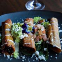 Enrolame la Flauta  · Crispy corn tortillas, chipotle chicken, topped with sour cream, queso fresco, pico de gallo...