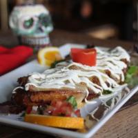 Pinono · Sweet plantain, ground beef or chicken, muenster and queso fresco, sour cream, pico de gallo.