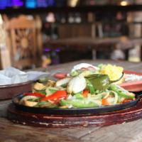 Aprietame la Faja Fajita · Flour tortillas, sautéed bell peppers & onions, rice & refried beans, guacamole, pico de gal...