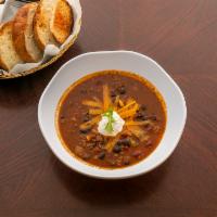 Beef Chili Soup · Spicy beef chili, topped with cheddar cheese and served with sour cream.  Served with bread