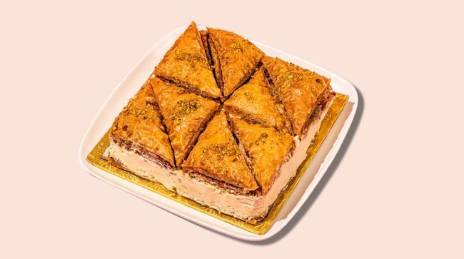 Signature Baklava Cheesecake Whole Cake · Serves 12- 14 
TWO AMAZING DESSERTS TOGETHER AS ONE. Our signature greek made baklava mixed with original creamy cheesecake.
This Baklava Cheesecake is a luscious twist on the traditional Greek dessert. With all the flavors of cinnamon, honey and walnuts, it’s a delicious way to mix together two delicious desserts into one!
Delivers Frozen for maximum freshness. Thaws in one hour & is ready to eat.