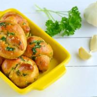 Garlic Knots · House-made dough, tied-up, dipped in garlicky goodness and oven-baked. Add cheese for an add...
