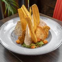 Guacamole  · Served with fried queso blanco, tostones, malanga chips and pico de gallo.