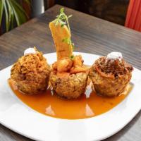 Mofonguitos Trio · Deep fried mashed plantain mixed with butter, garlic and pork stuffed with chicken, beef and...