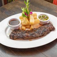 Churrasco · 10 oz. grilled skirt steak topped with demi glace, served with chimichurri, yucca fries.