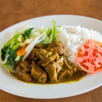 Goat Curry · Served with rice vegetables and plantain.