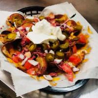 Loaded Nachos · Fresh tortillas fried covered with your choice of beef taco meat, diced chicken or pulled po...
