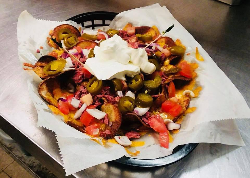 Loaded Nachos · Fresh tortillas fried covered with your choice of beef taco meat, diced chicken or pulled pork covered with shredded cheddar
cheese, shredded lettuce, diced onions, diced tomatoes and sliced jalapenos served with a side of sour cream and salsa. 
