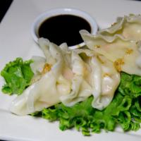 Steamed Veggie Dumpling · Steamed vegetable dumpling served with soy sauce.