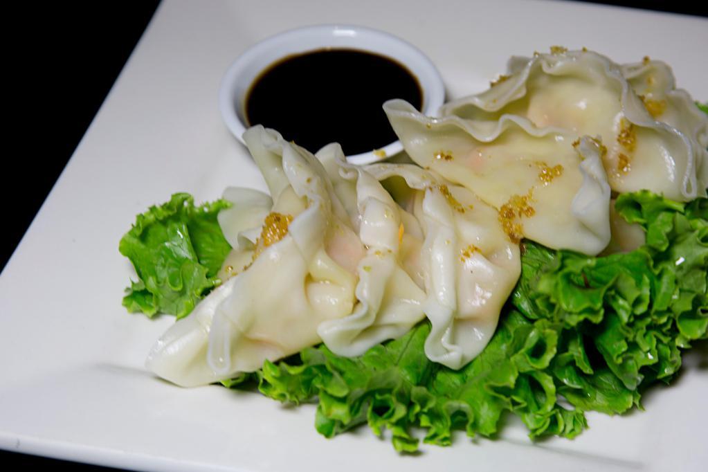Steamed Veggie Dumpling · Steamed vegetable dumpling served with soy sauce.