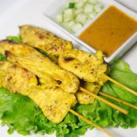 Satay Chicken · Chicken on skewers marinated with curry spice and Thai herbs. Served with peanut sauce and c...