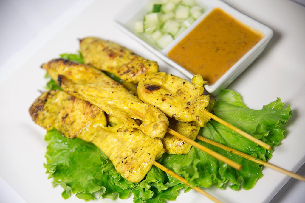 Satay Chicken · Chicken on skewers marinated with curry spice and Thai herbs. Served with peanut sauce and cucumber salad. 