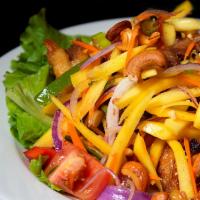 Duck Salad · Slices of crispy duck, sliced mango, tomato, onion, peanut and cashew nuts in tangy lime sau...