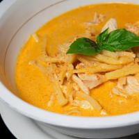 Red Curry · Red curry in coconut milk, bamboo shoot, basil leaves and Thai herbs. Served with steamed ri...