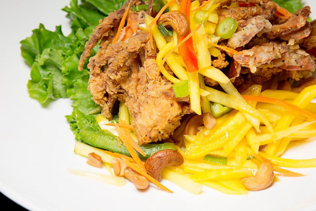 Softshell Crab Mango · 2 deep fried crabs topped with mango salad, served with jasmine rice.