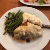 Le Cordon Bleu Dinner · Breaded chicken stuffed with ham and Swiss, served with mashed potatoes, green beans and blu...