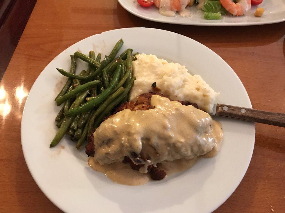 Le Cordon Bleu Dinner · Breaded chicken stuffed with ham and Swiss, served with mashed potatoes, green beans and blue cheese sauce.