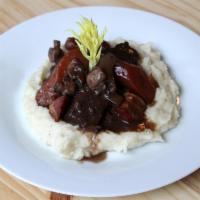Le Boeuf Bourguignon Dinner · Slowly braised beef in red wine sauce with mushrooms and bacon, served with mashed potatoes.