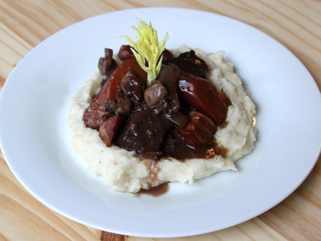 Le Boeuf Bourguignon Dinner · Slowly braised beef in red wine sauce with mushrooms and bacon, served with mashed potatoes.