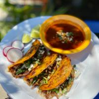 Birria Tacos  · 3 tacos consisting of shredded beef, cilantro, cheese and onion. Served with consomé dip. 