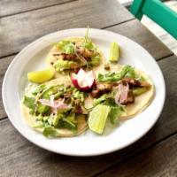 Grilled Octopus Tacos  · Grilled octopus, sliced jalapeño, arugula, avocado sauce, pickled onion, and pepitas. Comes ...