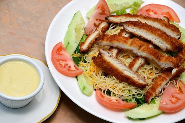 Honey Crispy Chicken Salad · Breaded crispy chicken breast over lettuce, tomatoes, cucumber, red onions, cheddar cheese and chilled angel hair pasta with honey mustard dressing.