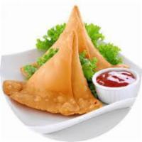 Vegetable Samosas · Crisp pastry filled with a mildly spiced mixture of potatoes and peas. 