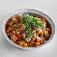 Aloo Tikki Chaat · Aloo tikki topped with spiced chicken peas, sweet yogurt, tamarind and cilantro sauce garnis...