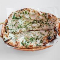 Garlic Naan · Topped with fresh minced garlic and cilantro.