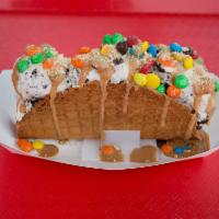 Chocolate 2 Step Taco · Cookies and cream ice cream, Reese's pieces, mini M&M's, crumbled Graham Crackers, and caram...