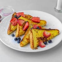 Brioche French Toast Breakfast · Fresh fruits, maple syrup, side of butter.