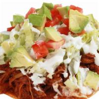 45. Tostada Jalisco · Shredded pork in Jalisco's style sauce, beans, lettuce, tomato, sour cream, and avocado with...