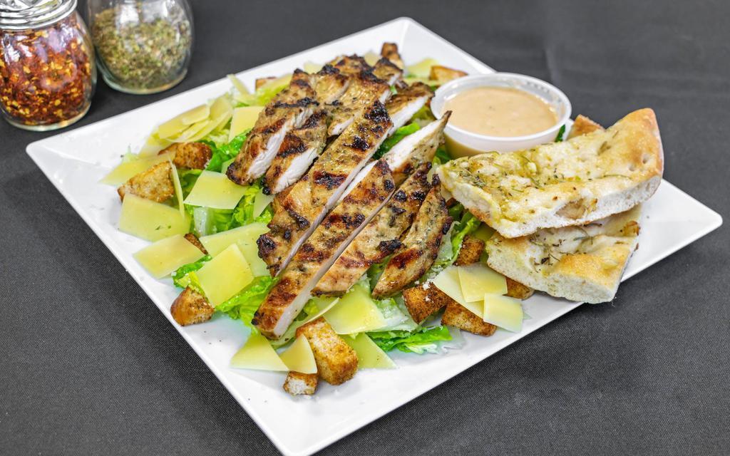 Caesar Salad · Romaine lettuce, Romano cheese, shaved Parmesan, roasted garlic croutons and homemade Caesar dressing.
