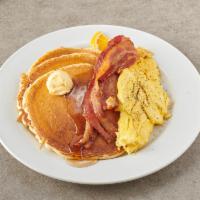Pancakes Deluxe · Served with 2 eggs and choice of meat.