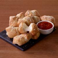 Stuffed Garlic Knots · 10 stuffed garlic knots. Filled with melted cheese and served with marinara dipping sauce.