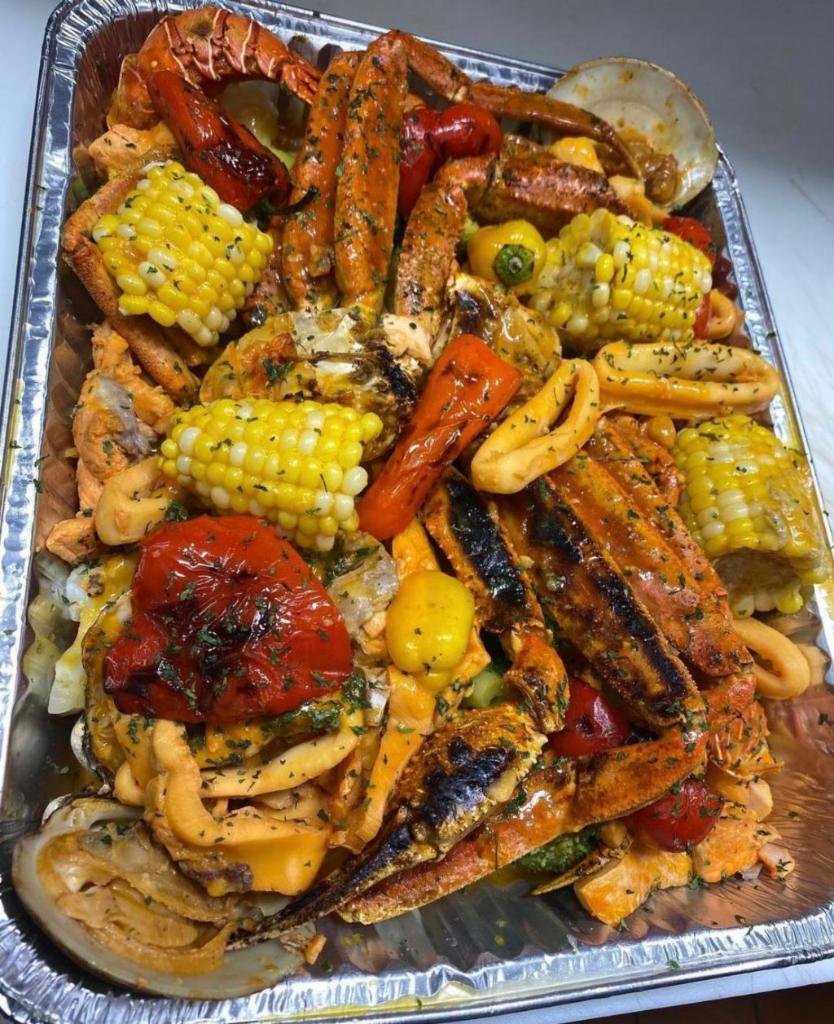 Peter's Grilled Seafood · Shrimps, salmon, fish filet, lobster, calamari, crab legs , clams ,corn  and green plantain 
