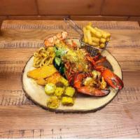 Parillada de langosta  · calamari, salmon, lobster, corn, and fried cassava