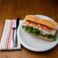 7. Turkey Club BLT Sandwich · Ovengold turkey, bacon, lettuce, tomato, avocado and mayonnaise.