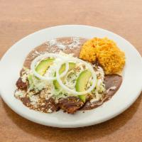 Enchiladas · 3 corn tortillas rolled in mole or green sauce, topped with cream, lettuce, queso fresco, re...