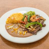 Tex Mex Fajitas · Served with sauteed onions, peppers, rice, beans, guacamole and sour cream with a soft flour...