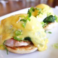 Eggs Benedict · Free range poached eggs on a toasted English muffin topped with creamy hollandaise sauce wit...